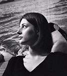 Woman in profile looking left, black and white wavy water background.