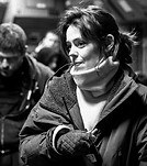 Sigourney Weaver bundled in a warm coat, scarf, and gloves, looking right.